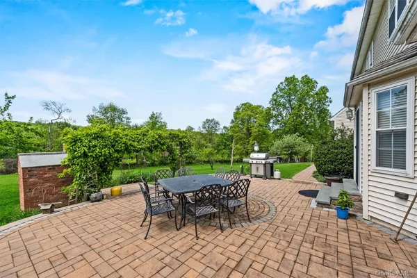 a view of a house with a yard and sitting area