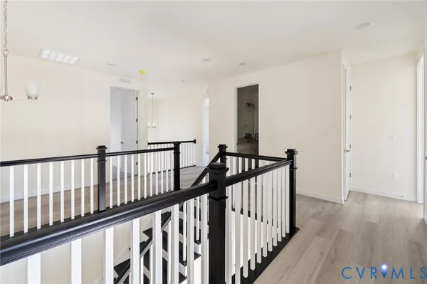 a view of a hallway with wooden floor