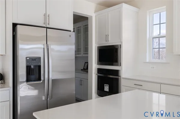 a kitchen with a refrigerator and a window