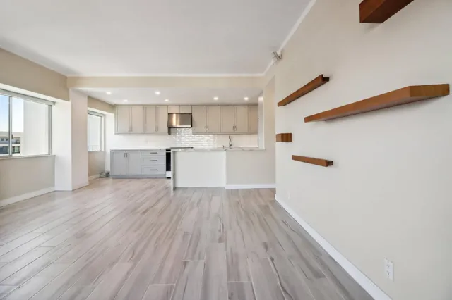 a view of a kitchen with a sink and a refrigerator