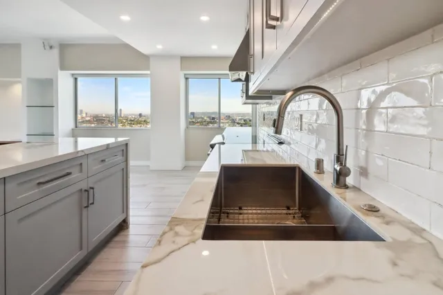 a kitchen with a sink stove and cabinets