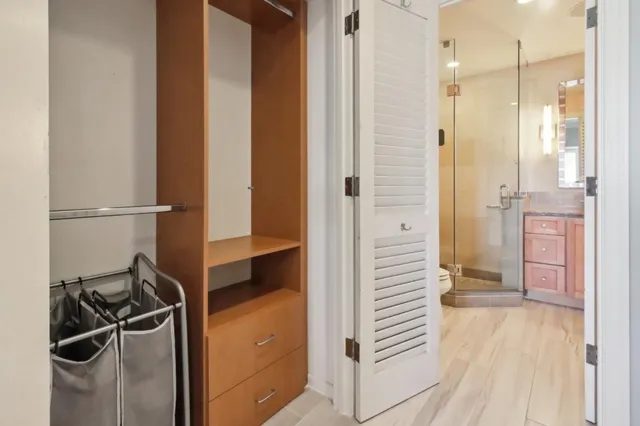 a bathroom with a granite countertop mirror and a shower