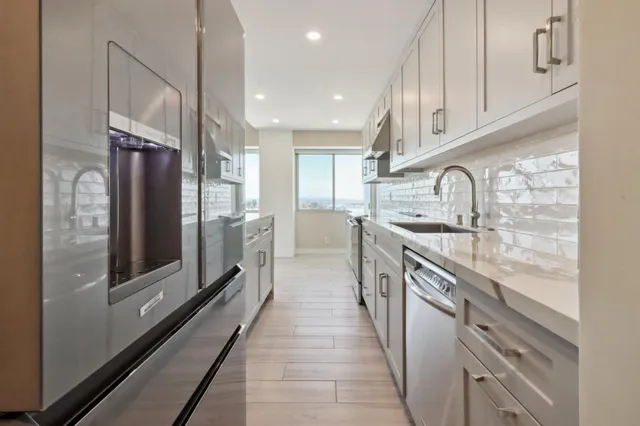 a view of kitchen with wooden floor and electronic appliances