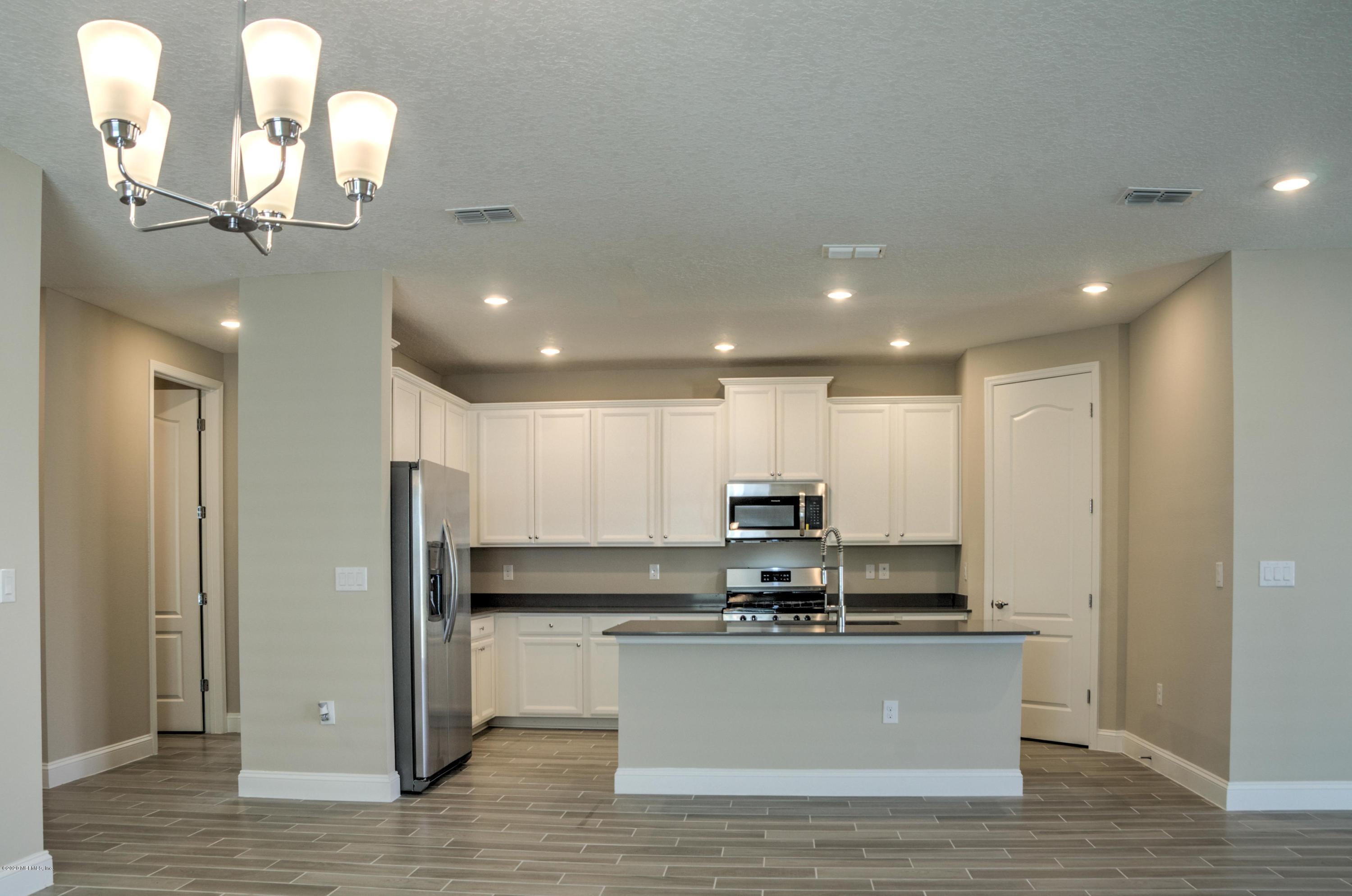 75 Dade Court St. Augustine, FL 32092 - Photo 12 of 25 a view of kitchen with stainless steel appliances refrigerator stove microwave and cabinets