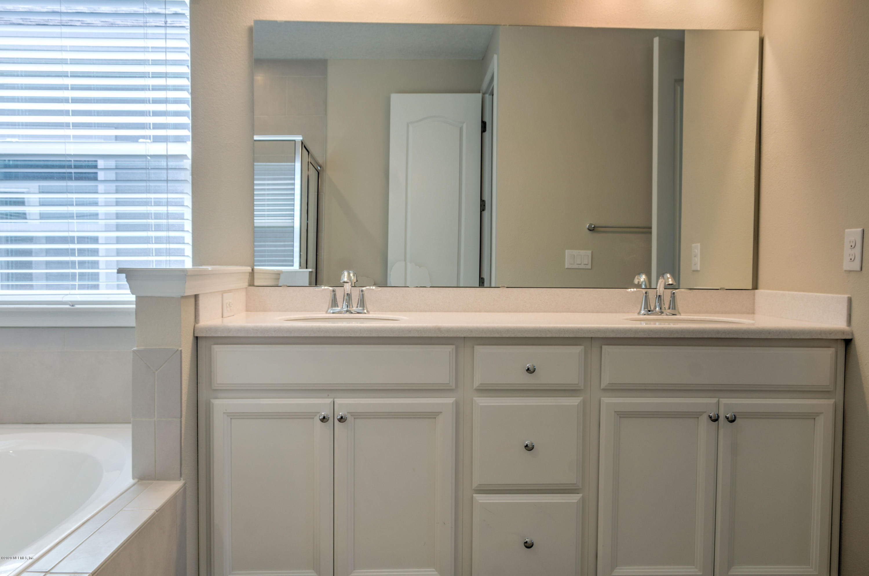 75 Dade Court St. Augustine, FL 32092 - Photo 15 of 25 a bathroom with a sink and a mirror