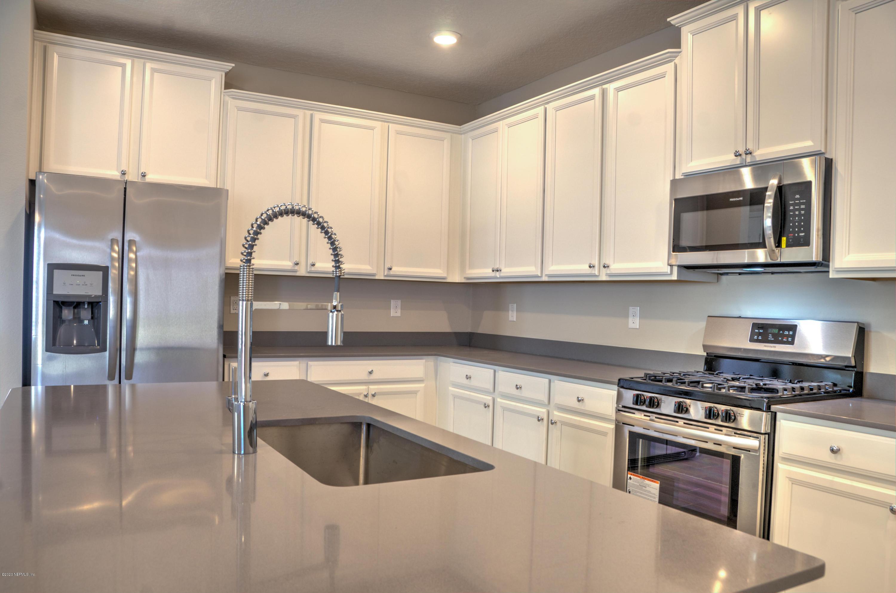 75 Dade Court St. Augustine, FL 32092 - Photo 2 of 25 a kitchen with stainless steel appliances granite countertop a sink a stove and cabinets