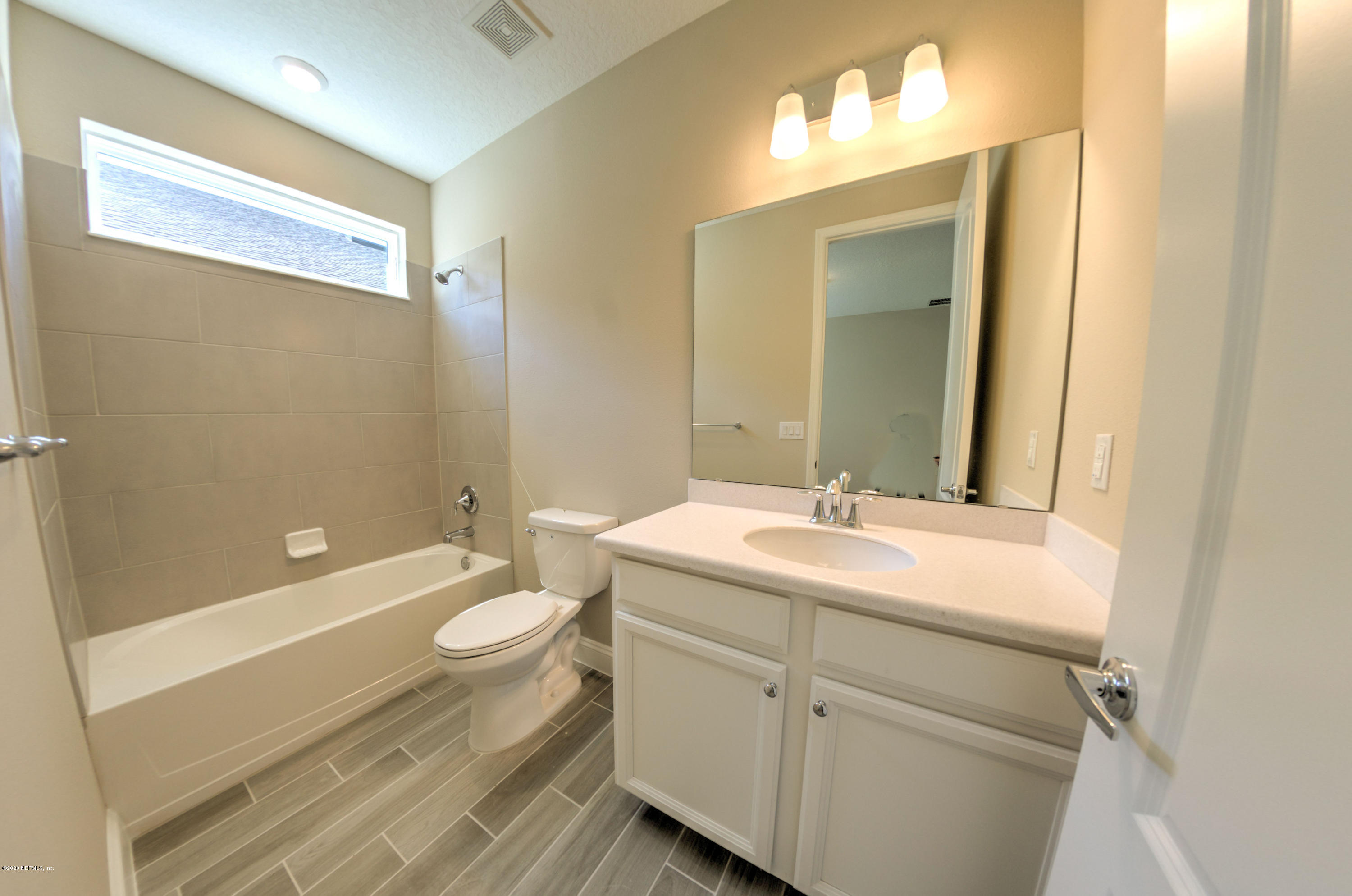 75 Dade Court St. Augustine, FL 32092 - Photo 5 of 25 a bathroom with a double vanity sink toilet and mirror