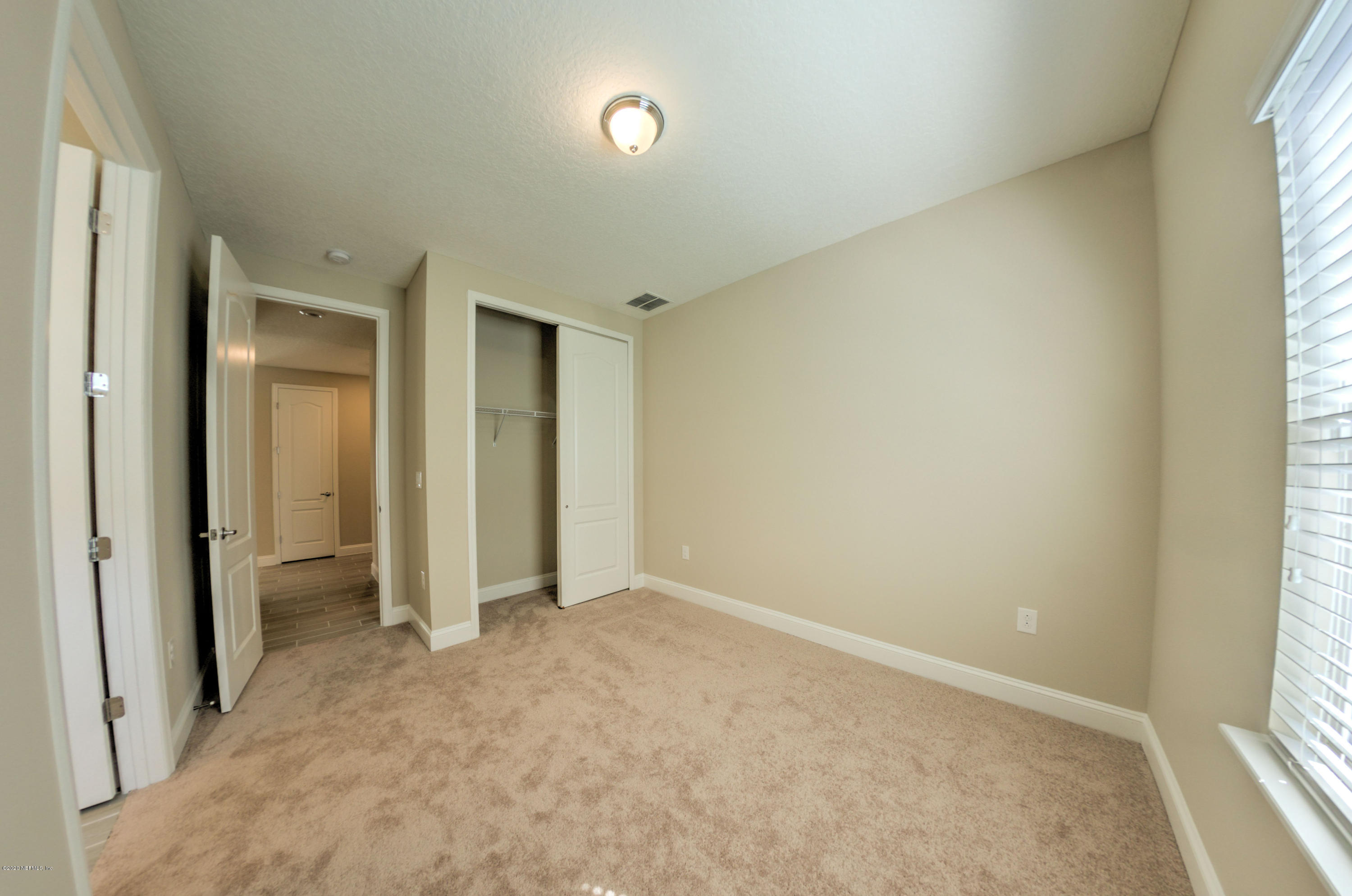 75 Dade Court St. Augustine, FL 32092 - Photo 6 of 25 an empty room with a window and a bathroom