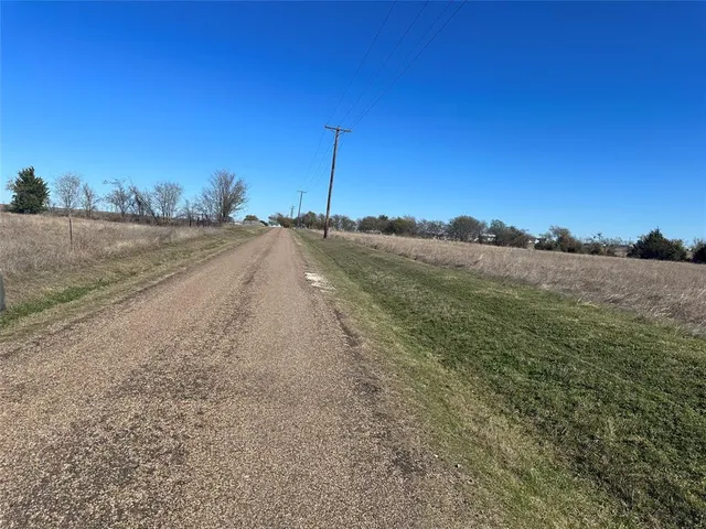 a view of a road with a yard