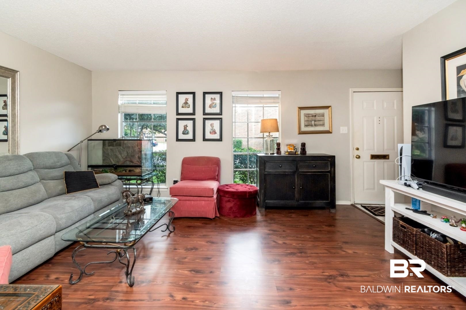 118 Du Rhu Drive, Unit H Mobile, AL 36608 - Photo 2 of 19 Open-concept living space featuring wood-finish flooring, multiple windows providing natural light, and a white paneled entry door