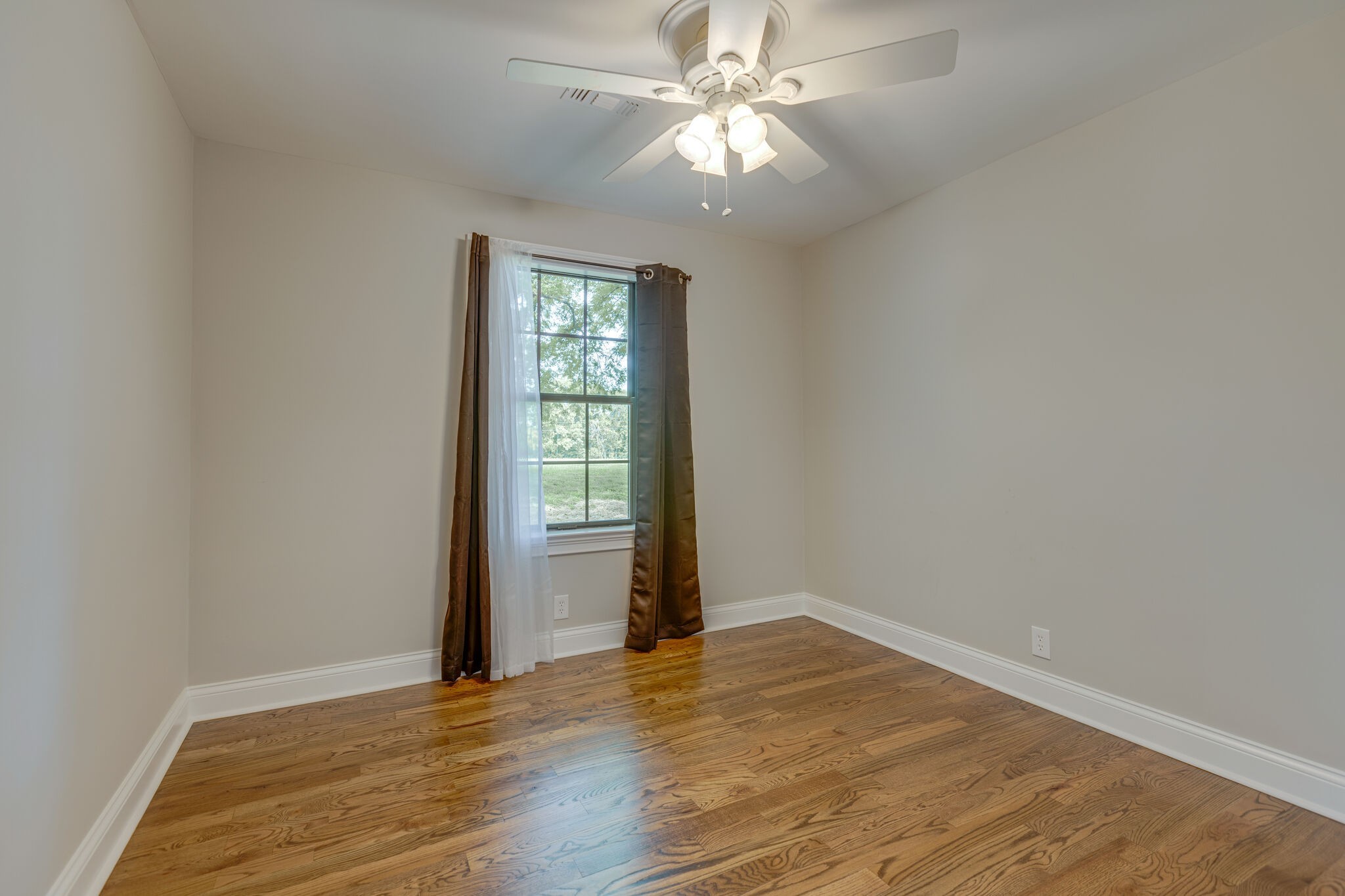 4223 Holder Road Franklin, TN 37067 - Photo 22 of 39 an empty room with wooden floor chandelier fan and windows