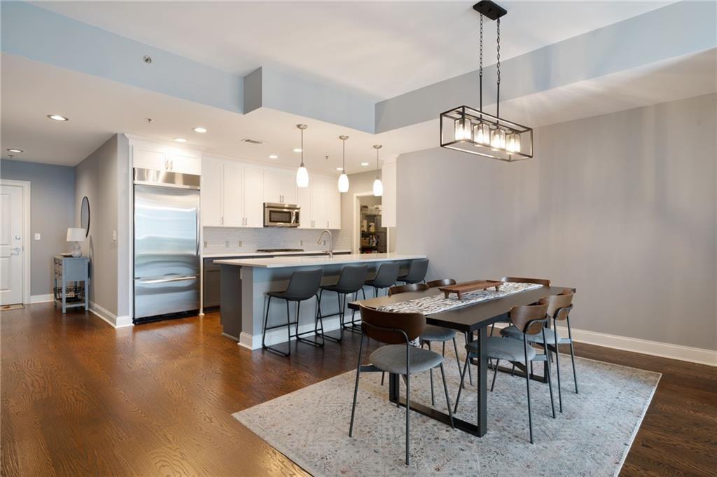 a view of a dining room with furniture wooden floor and chandelier