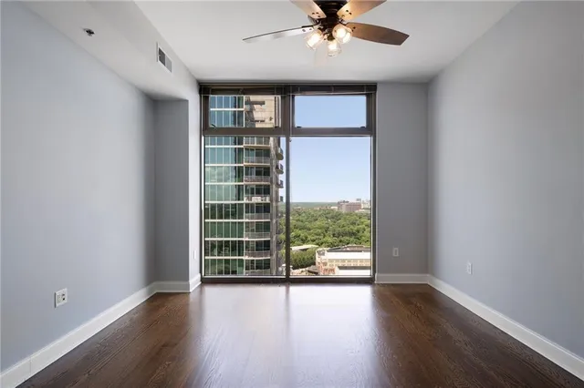 wooden floor in an empty room with a window