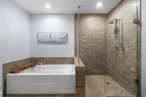a bathroom with a shower and a bath tub