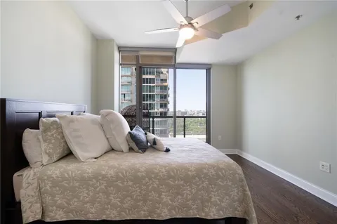 a bedroom with a large bed and a large window