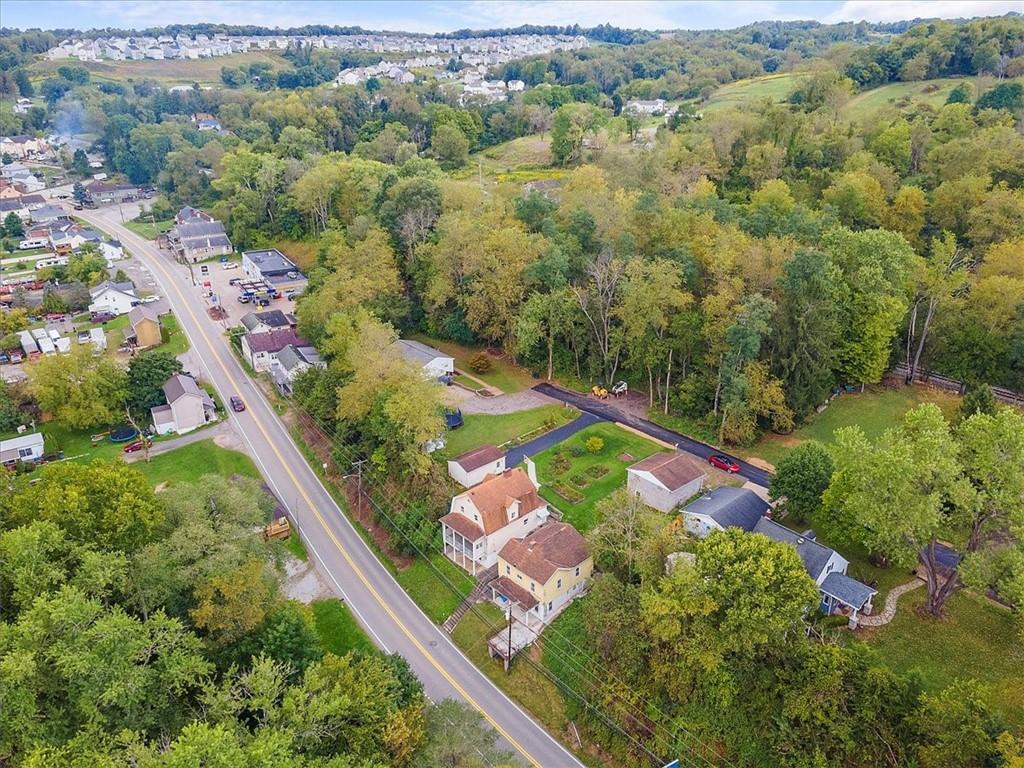 an aerial view of a house with a yard