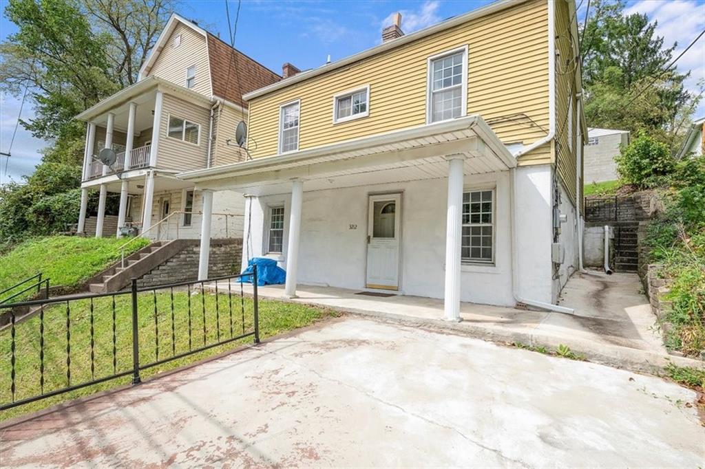 3212 Millers Run Road Cecil, PA 15321 - Photo 2 of 25 a view of a white house with large windows and a small yard