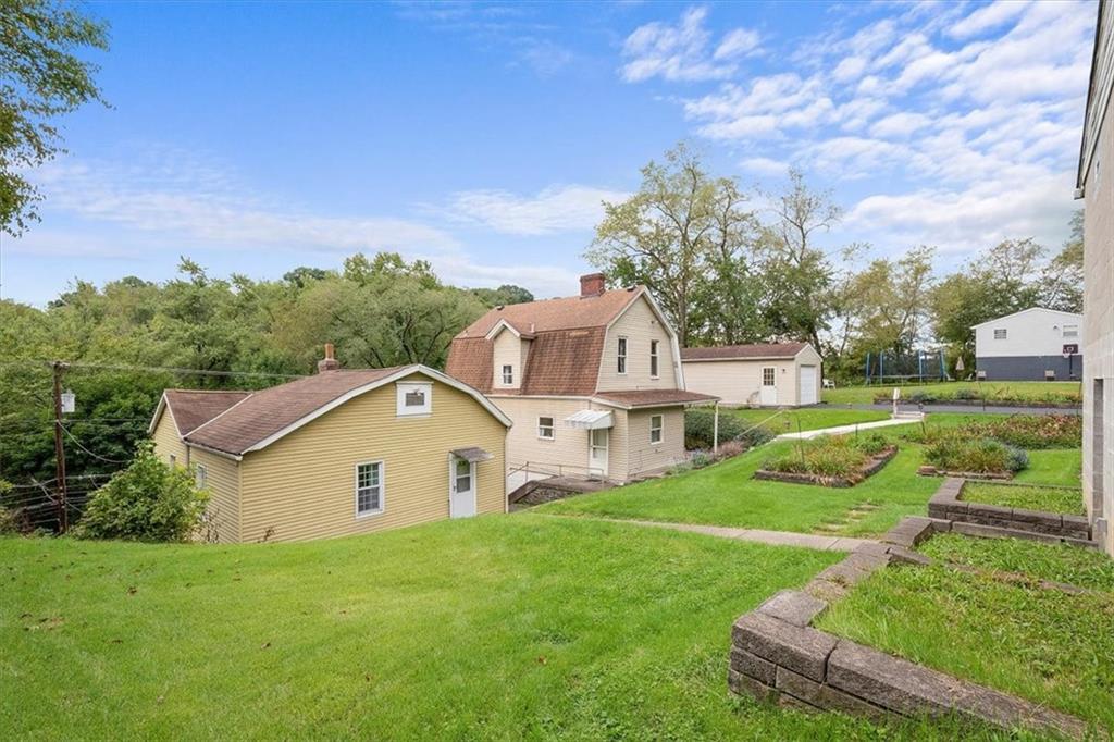3212 Millers Run Road Cecil, PA 15321 - Photo 23 of 25 a view of a house with yard and a garden