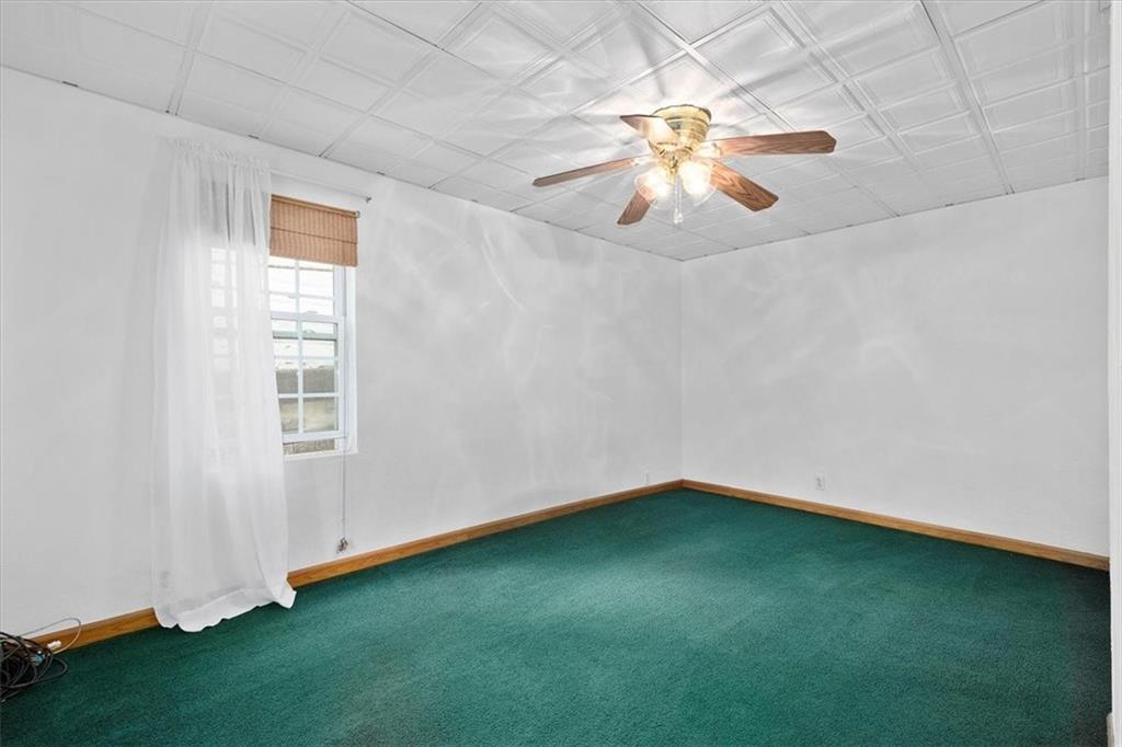 3212 Millers Run Road Cecil, PA 15321 - Photo 5 of 25 an empty room with a window and a chandelier fan