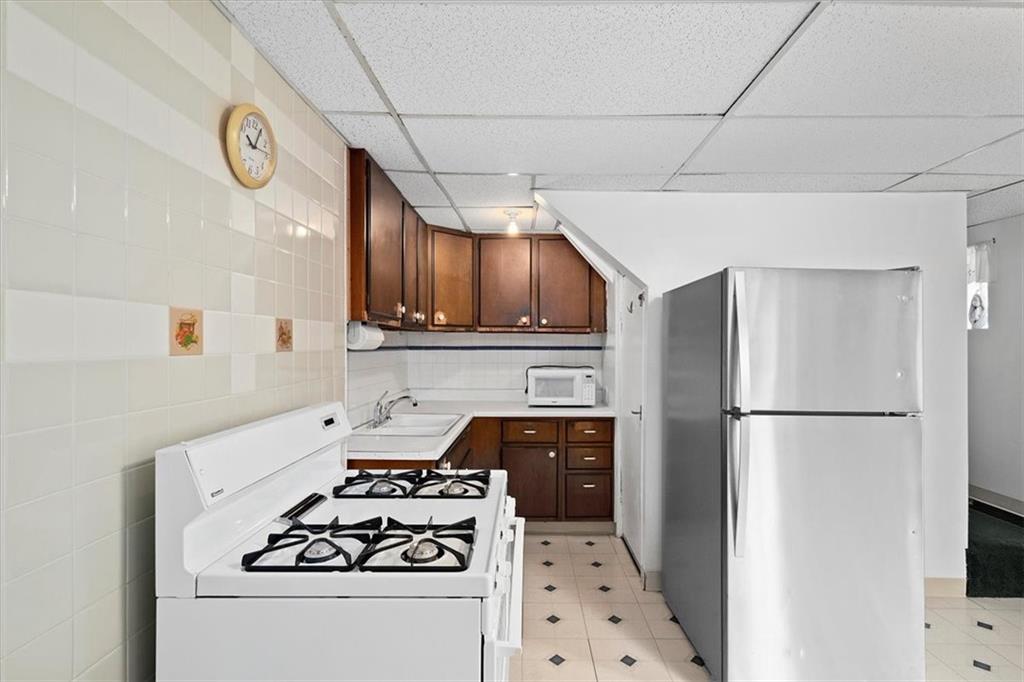 3212 Millers Run Road Cecil, PA 15321 - Photo 8 of 25 a kitchen with granite countertop a sink a stove and refrigerator