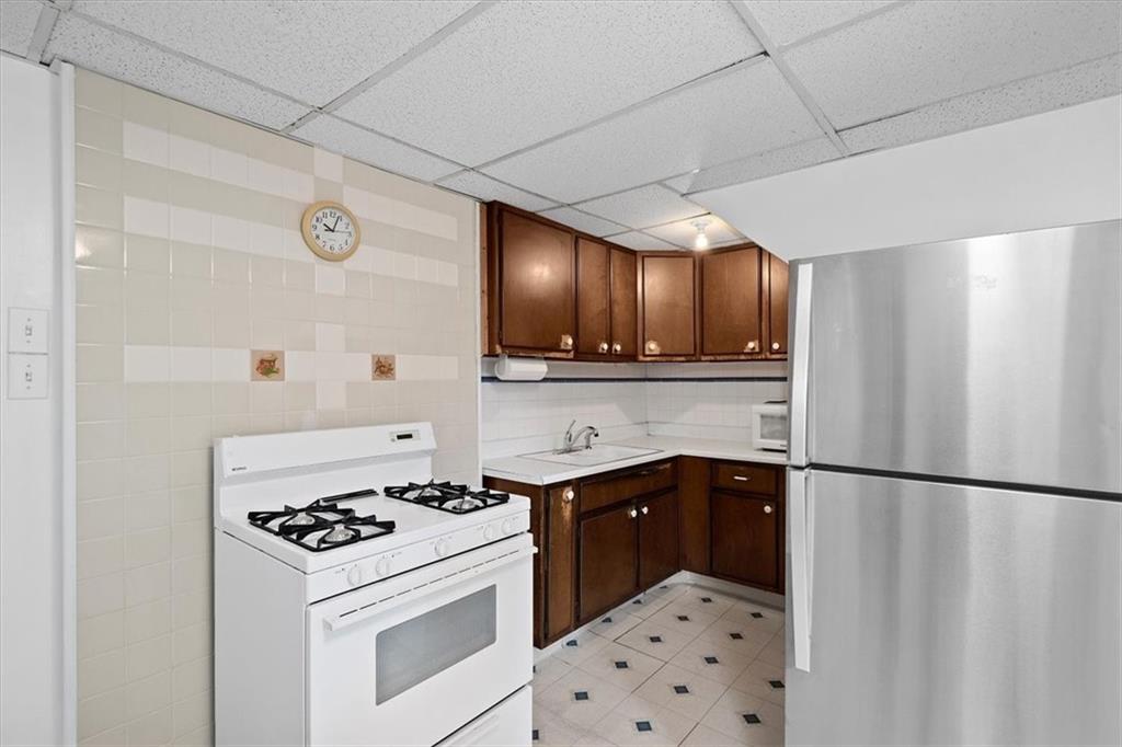 3212 Millers Run Road Cecil, PA 15321 - Photo 9 of 25 a kitchen with a sink a stove and refrigerator