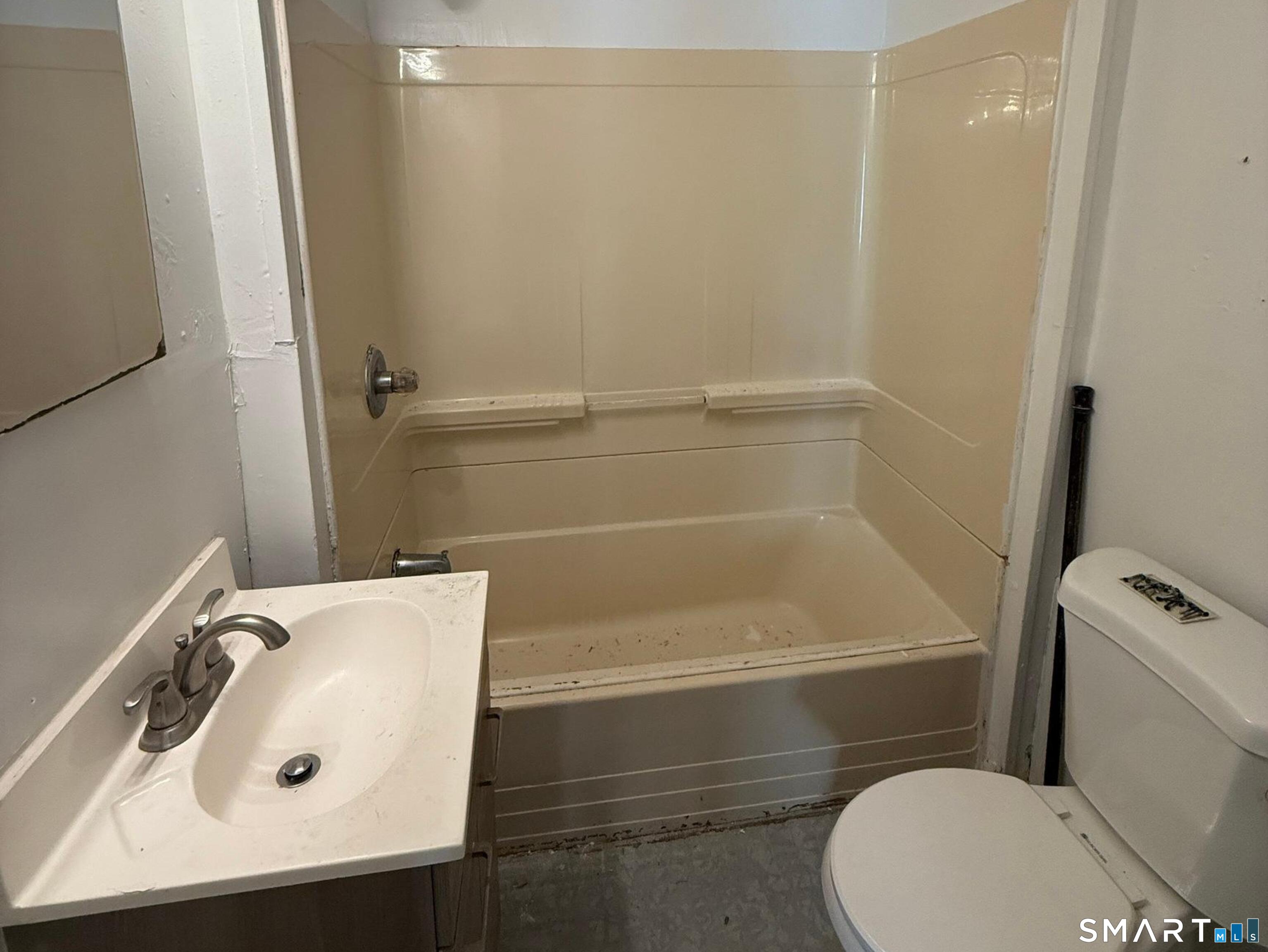 33 Olive Street Meriden, CT 06450 - Photo 7 of 10 a bathroom with a sink a toilet and shower