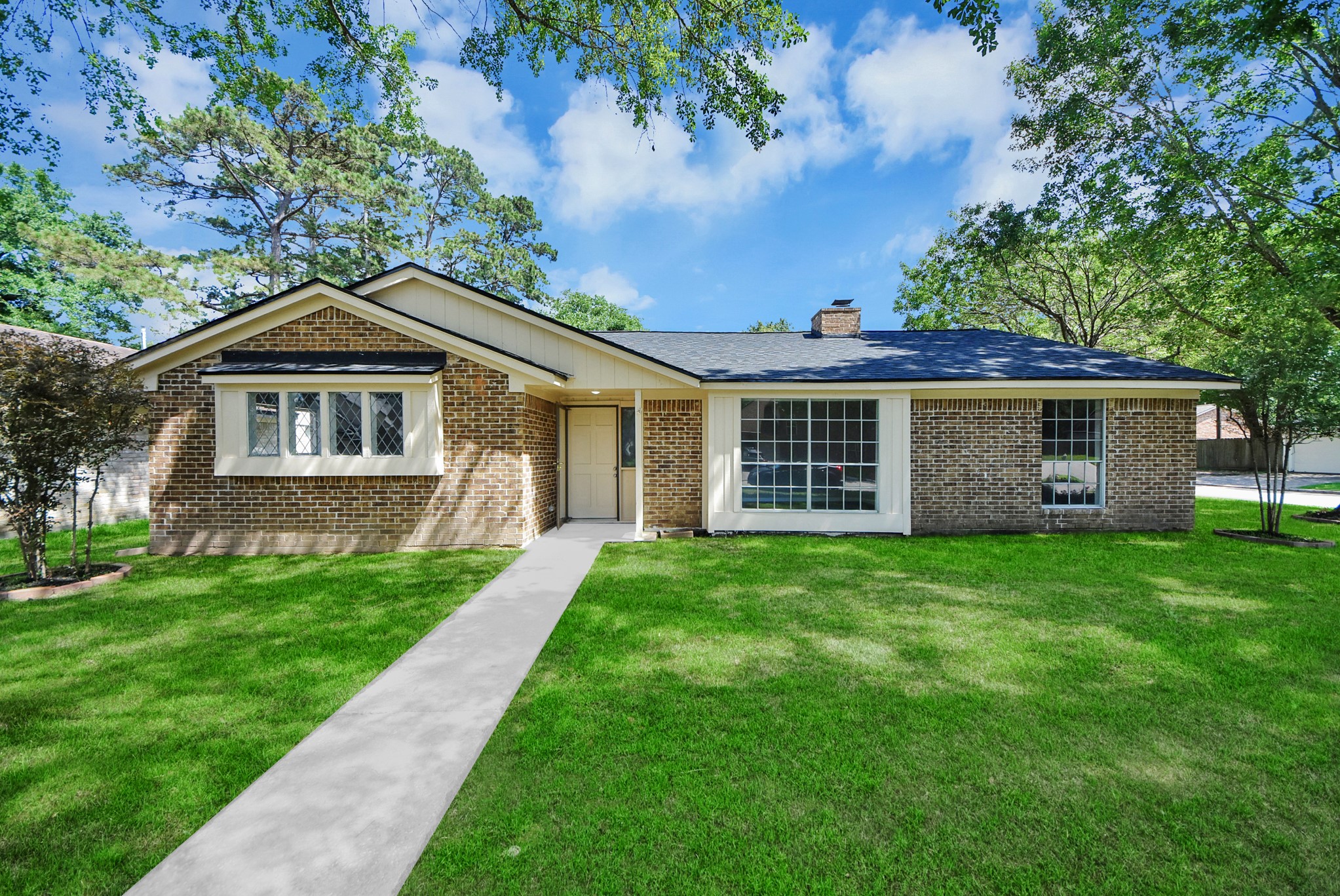 2402 Rolling Glen Drive Spring, TX 77373 - Photo 2 of 38 a front view of a house with a yard
