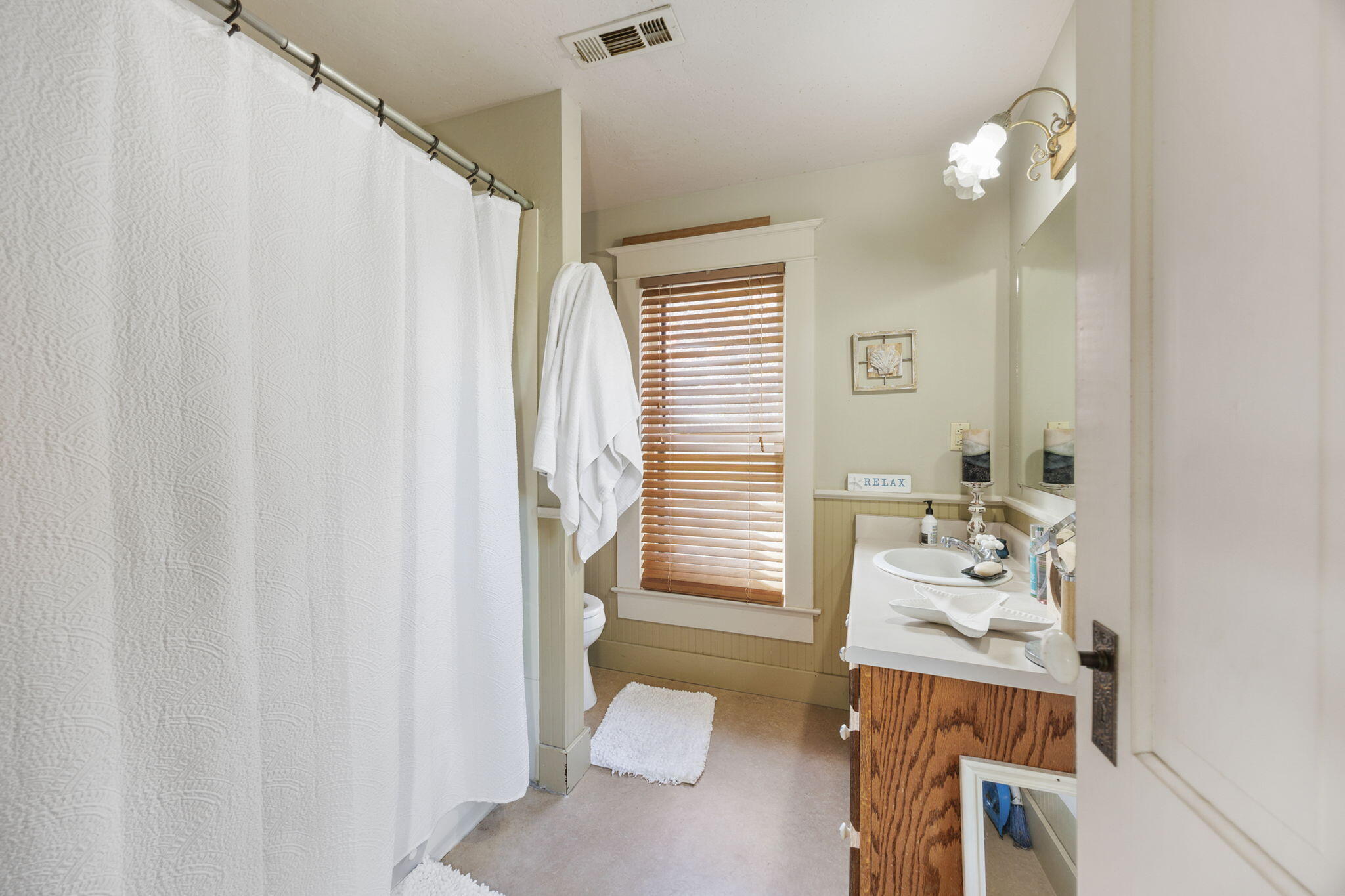75 Wimer Street Ashland, OR 97520 - Photo 23 of 44 a bathroom with a sink a toilet and shower curtain