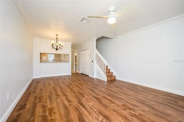 a view of empty room with wooden floor