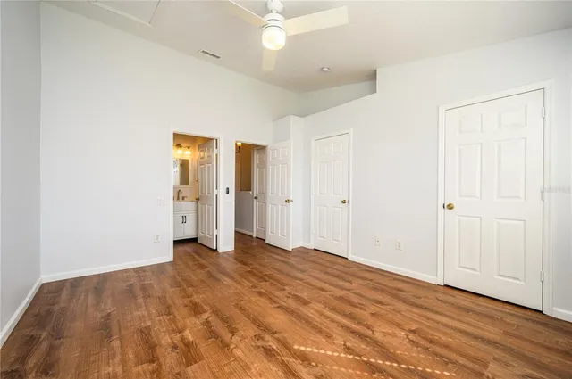 a view of an empty room with wooden floor
