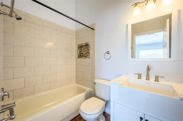 a bathroom with a sink mirror toilet and bathtub