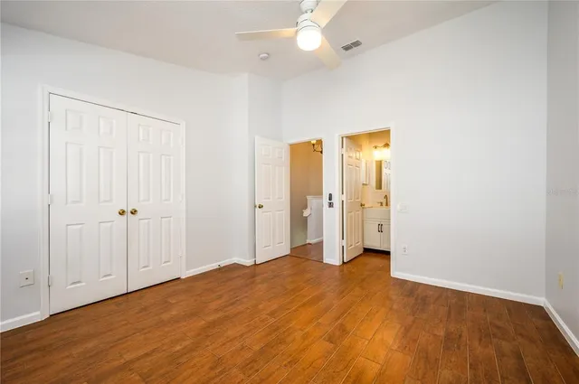 an empty room with closet and a bathroom