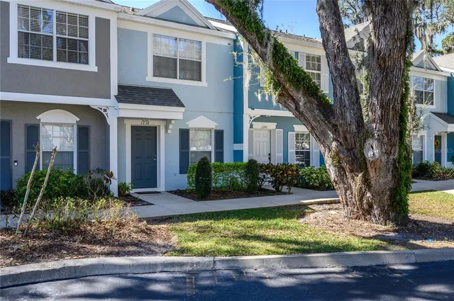 a front view of a house with yard and green space