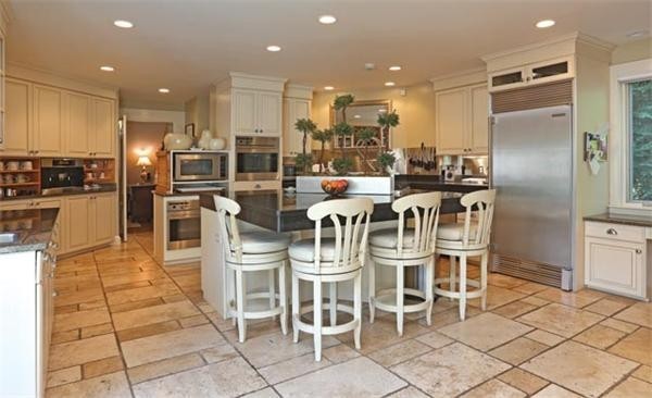 63 May Street Boston, MA 02130 - Photo 6 of 11 a dining room with stainless steel appliances furniture a rug and a kitchen view