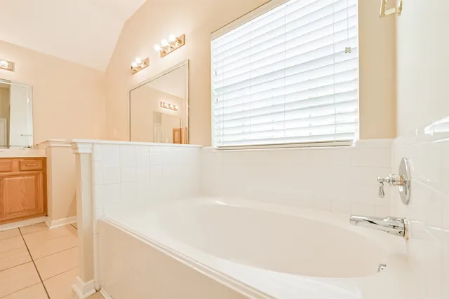 a white bath tub sitting next to a white sink