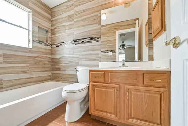 a bathroom with a sink a toilet and bathtub