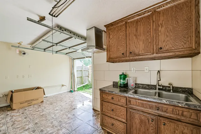 a kitchen with a sink and cabinets