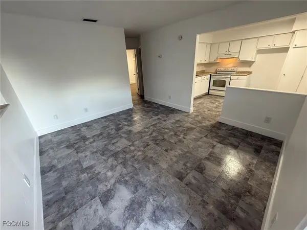 a view of a livingroom with furniture and a window
