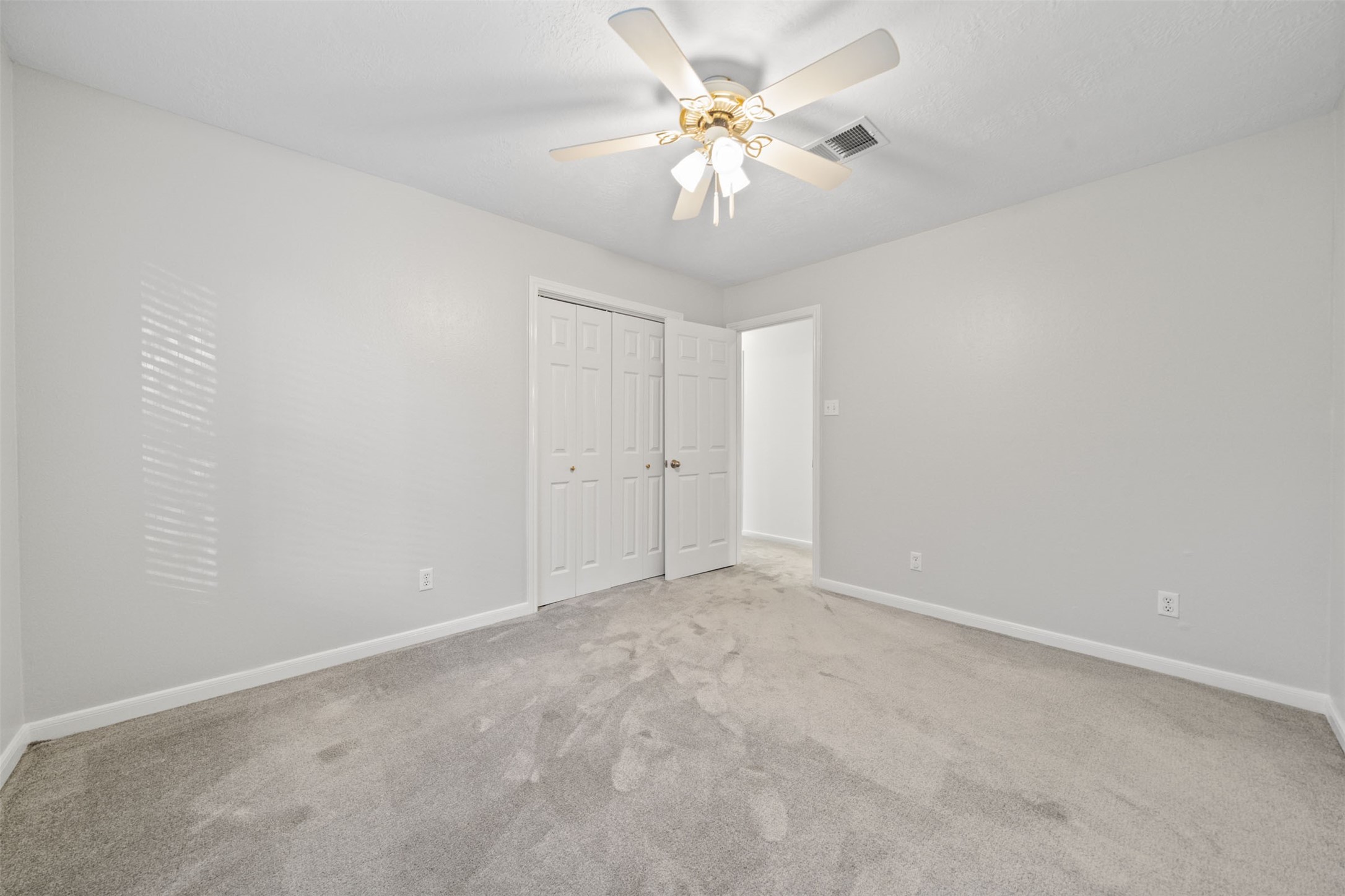 22323 Roberts Cemetery Road Hockley, TX 77447 - Photo 30 of 50 an empty room with chandelier fan and closet area