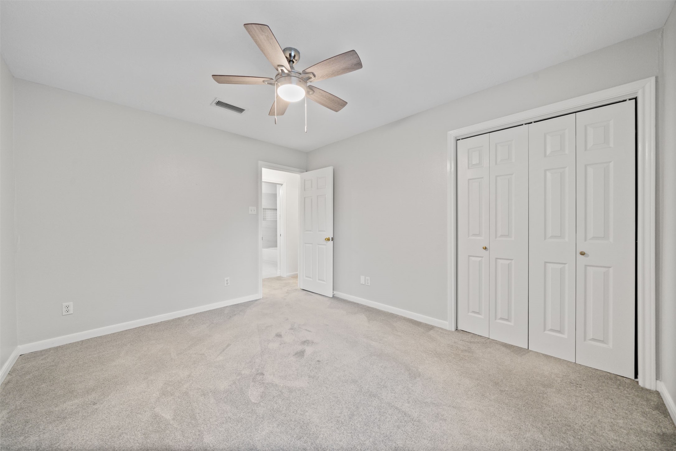 22323 Roberts Cemetery Road Hockley, TX 77447 - Photo 32 of 50 an empty room with a chandelier fan and closet area