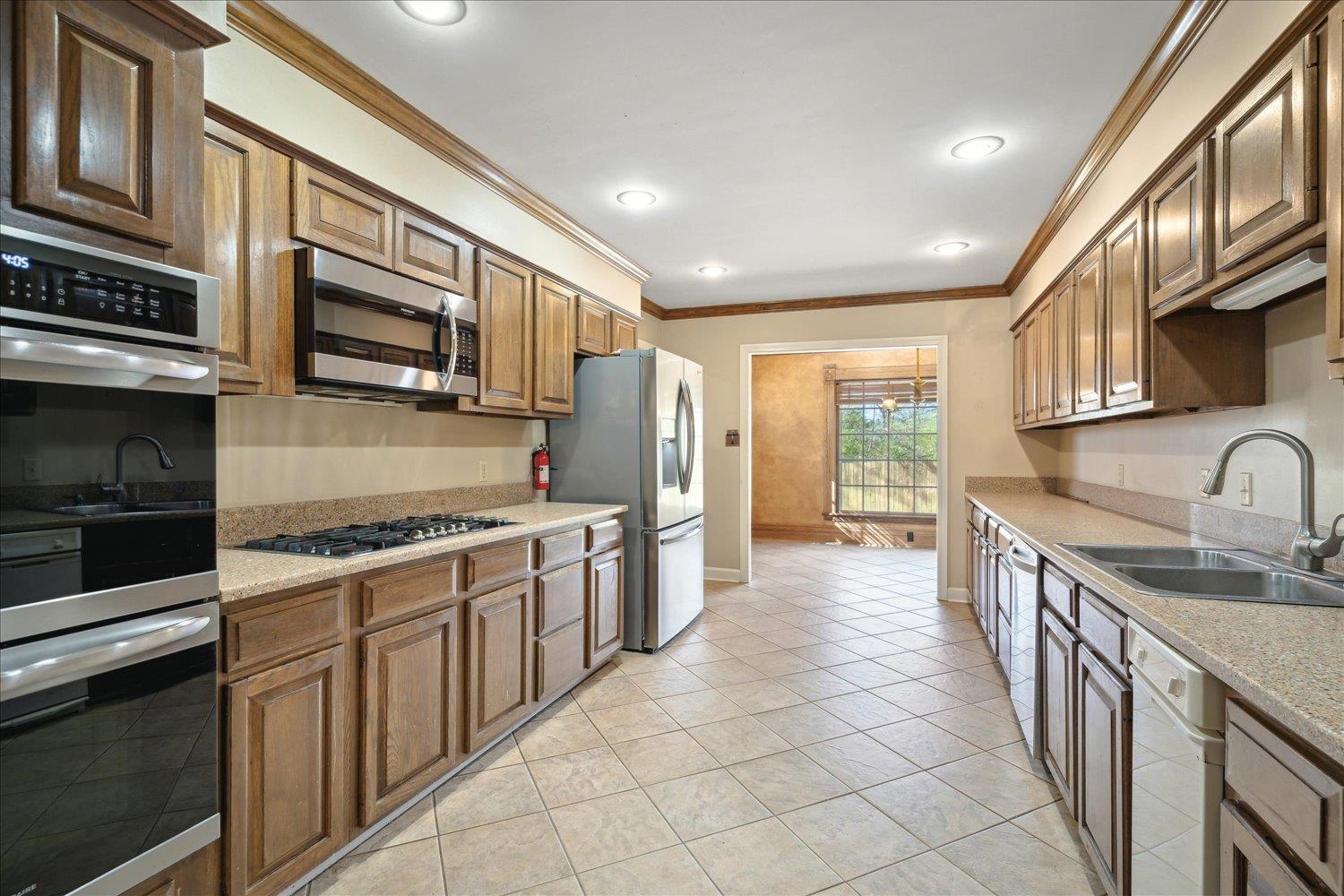 5680 Herald Square Memphis, TN 38120 - Photo 18 of 39 a kitchen with stainless steel appliances granite countertop a stove and a sink