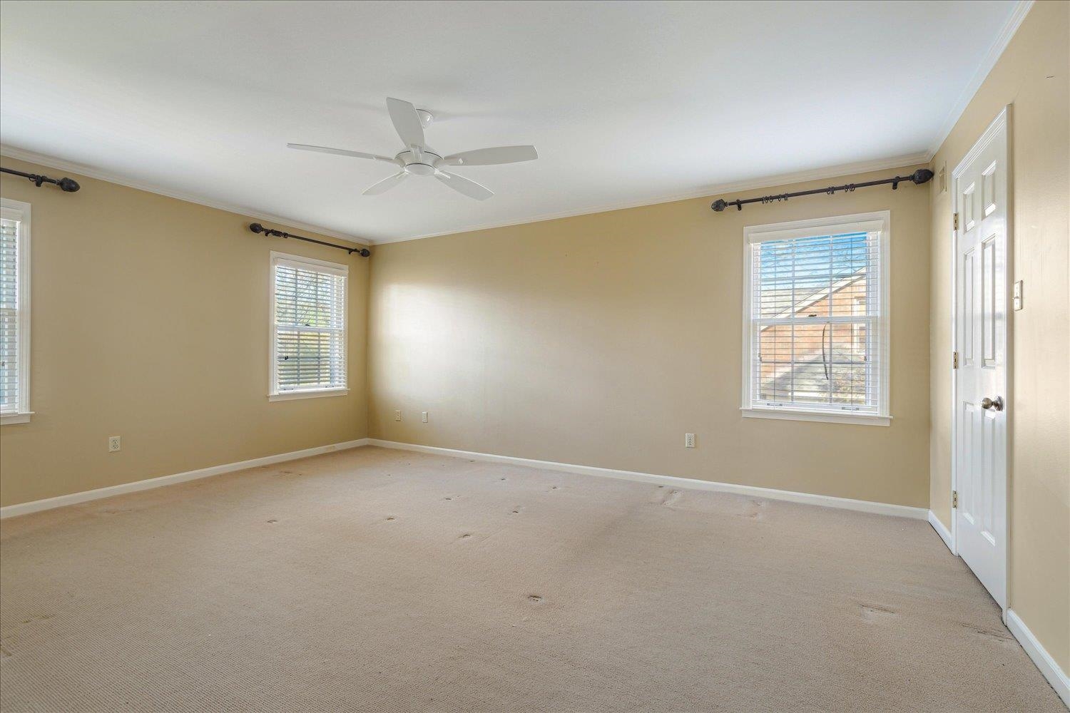 5680 Herald Square Memphis, TN 38120 - Photo 26 of 39 a view of an empty room with windows and chandelier fan