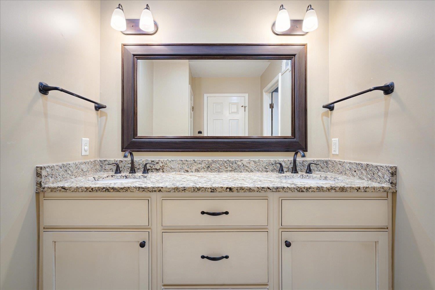 5680 Herald Square Memphis, TN 38120 - Photo 35 of 39 a bathroom with a granite countertop sink vanity and mirror