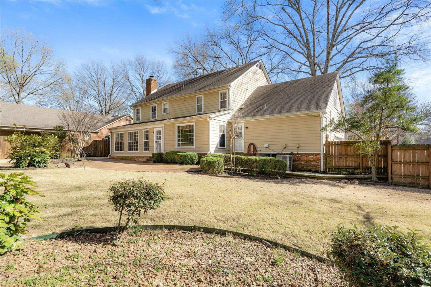 5680 Herald Square Memphis, TN 38120 - Photo 37 of 39 a front view of a house with a yard covered with snow and trees