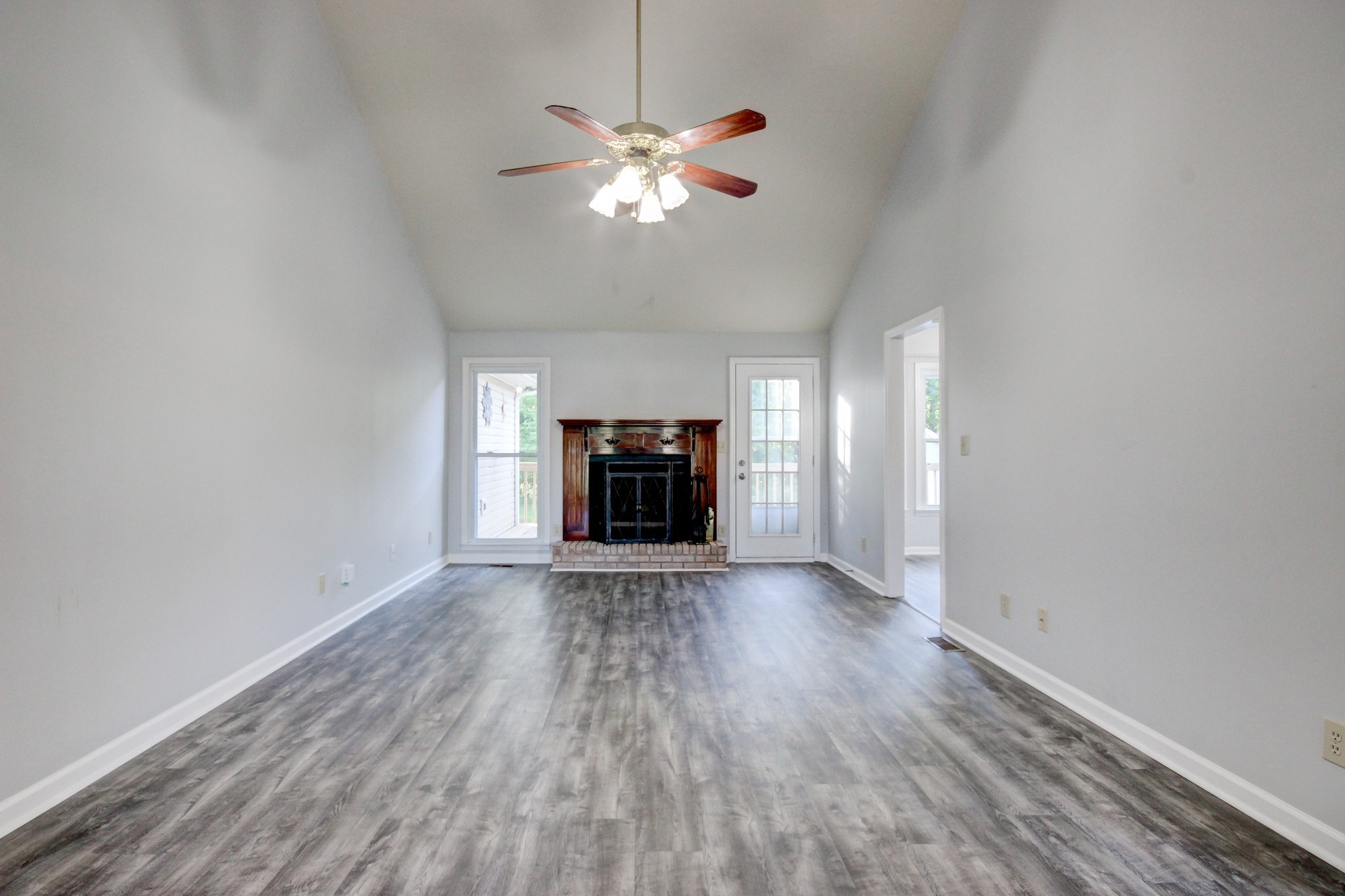 1460 McClardy Road Clarksville, TN 37042 - Photo 2 of 15 an empty room with wooden floor chandelier and fan
