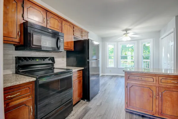 a kitchen with stainless steel appliances granite countertop a stove and a microwave