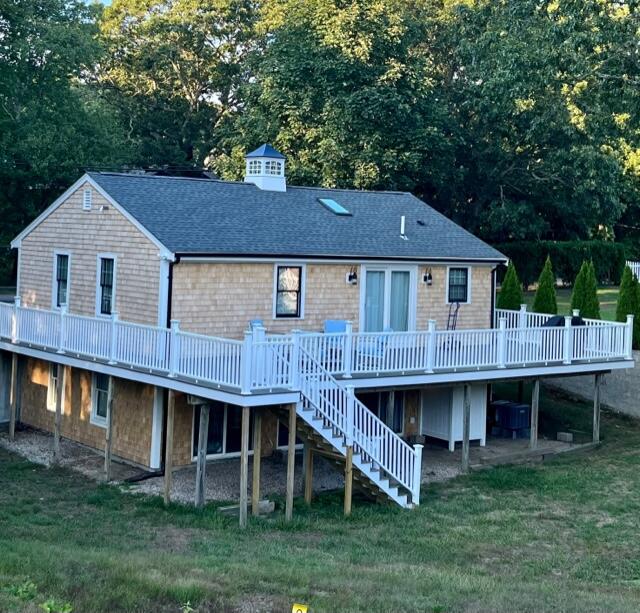 39 Nickerson Road Cotuit, MA 02635 - Photo 14 of 14 a view of a house with a garden and deck