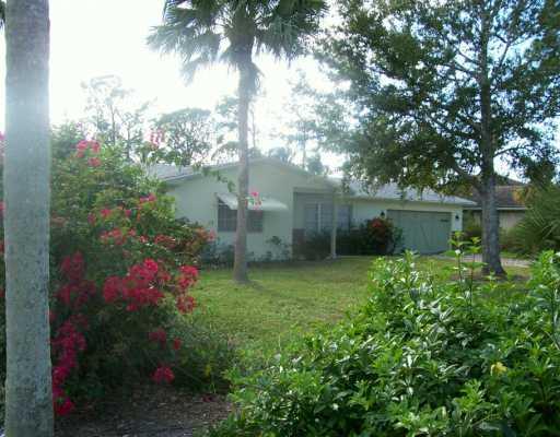 1904 Northwest Pine Tree Way Stuart, FL 34994 - Photo 2 of 8 a view of a garden with a tree