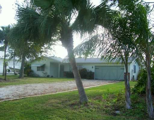 1904 Northwest Pine Tree Way Stuart, FL 34994 - Photo 3 of 8 a view of a house with a yard