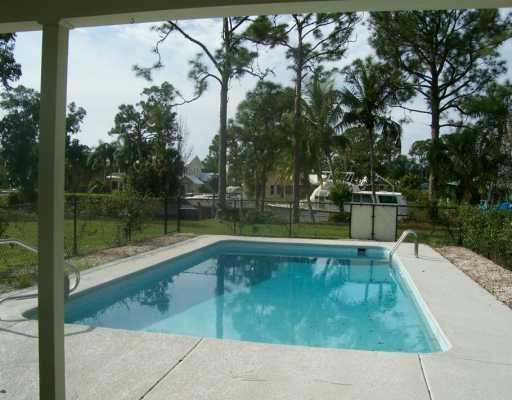 1904 Northwest Pine Tree Way Stuart, FL 34994 - Photo 4 of 8 a view of a swimming pool with a backyard